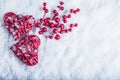 Two beautiful vintage red hearts with mistletoe berries on a white snow background. Christmas, love and St. Valentines Day concept Royalty Free Stock Photo