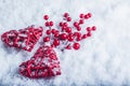 Two beautiful vintage red hearts with mistletoe berries on a white snow background. Christmas, love and St. Valentines Day concept Royalty Free Stock Photo