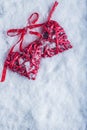 Two beautiful vintage red hearts tied together with a ribbon on a white snow background. Love and St. Valentines Day concept. Royalty Free Stock Photo