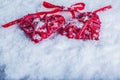 Two beautiful vintage red hearts tied together with a ribbon on a white snow background. Love and St. Valentines Day concept. Royalty Free Stock Photo