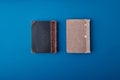 Two beautiful vintage small format books with scuffs and scratches on black and gray hardcovers. Royalty Free Stock Photo