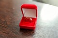 Two beautiful wedding rings on red jewelry box on light background Royalty Free Stock Photo