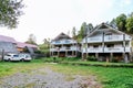 Two beautiful white wooden chalet cottages Houses and 2 white cars in mountain village beautiful rural landscape. modern Royalty Free Stock Photo