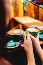 Two beautiful woman keeping cups of coffee. Royalty Free Stock Photo