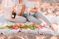 .Two beautiful women with blond hair in bright clothes. Sexy girls on the beach, romantic picnic with champagne and flowers. .Idea Royalty Free Stock Photo