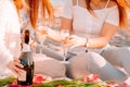 .Two beautiful women with blond hair in bright clothes. Sexy girls on the beach, romantic picnic with champagne and flowers. .Idea Royalty Free Stock Photo