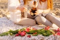 .Two beautiful women with blond hair in bright clothes. Sexy girls on the beach, romantic picnic with champagne and flowers. .Idea Royalty Free Stock Photo