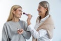 Two beautiful women doing make up and looking contented Royalty Free Stock Photo