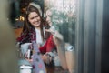 Two beautiful women drinking coffee and chatting in cafe