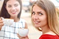 Two beautiful women drinking coffee at outside bar Royalty Free Stock Photo