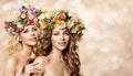 Two Beautiful Women in Flower Wreath Hat, Fashion Models Beauty Portrait with Roses Flowers in Hairstyle