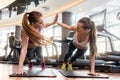 Two beautiful women giving high five while practicing basic plan