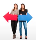 Two beautiful women holding red and blue arrow, left and right Royalty Free Stock Photo