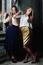 Two beautiful women posing in obsolete interior. Royalty Free Stock Photo