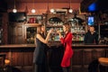 Two beautiful women are relaxing in the bar