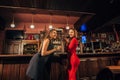 Two beautiful women are relaxing in the bar