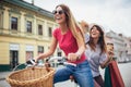 Two beautiful women shopping on bike in the city Royalty Free Stock Photo