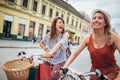 Two beautiful women shopping on bike in the city Royalty Free Stock Photo