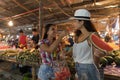 Two Beautiful Women Tasting Watermelon On Traditional Street Market In Asia Young Girls Tourists Buying Fresh Fruits On