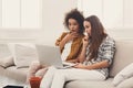 Two beautiful women using laptop at home Royalty Free Stock Photo