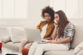 Two beautiful women using laptop at home Royalty Free Stock Photo