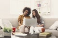 Two beautiful women using laptop at home Royalty Free Stock Photo