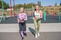 Two beautiful, young and athletic girls running on a street playground. Royalty Free Stock Photo