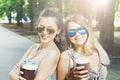 Two beautiful young boho chic stylish girls walking in park. Royalty Free Stock Photo