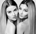 Two beautiful young european sisters or girlfriends women with clean skin and well-groomed hair