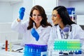 Two beautiful young female scientists working in laboratory with test tubes doing some research Royalty Free Stock Photo