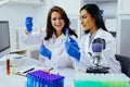 Two beautiful young female scientists working in laboratory with test tubes doing some research Royalty Free Stock Photo