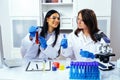 Two beautiful young female scientists working in laboratory with test tubes doing some research Royalty Free Stock Photo