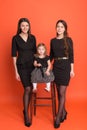 Two beautiful young girls in business suits and a little girl in Royalty Free Stock Photo