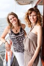 Two beautiful young girls on deck of ship