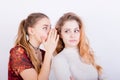 Two beautiful young girls share gossip Royalty Free Stock Photo