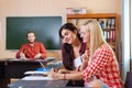 Two Beautiful Young Girls Using Tablet Computer High School, Smiling Students Wear Checked Shirt Royalty Free Stock Photo