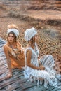 Two beautiful young stylish women wearing turban outdoors at sunset