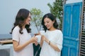 Two beautiful young well-dressed women chatting outdoors over co Royalty Free Stock Photo