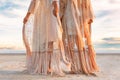 Two beautiful young woman in elegant boho dresses oudoors at sunset Royalty Free Stock Photo