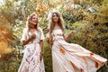 Two beautiful young woman in summer dresses outdoors at sunset Royalty Free Stock Photo