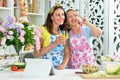 Portrait of two beautiful young women cooking together in kitchen Royalty Free Stock Photo