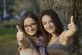 Two beautiful young women giving thumbs up sign Royalty Free Stock Photo