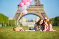 Two young women having picnic near the Eiffel tower in Paris, France Royalty Free Stock Photo