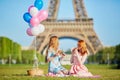 Two young women having picnic near the Eiffel tower in Paris, France Royalty Free Stock Photo