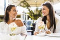 Two beautiful young women smiling and having a fruit salad in a Royalty Free Stock Photo