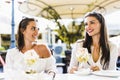 Two beautiful young women smiling and having a fruit salad in a Royalty Free Stock Photo