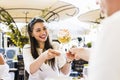 Two beautiful young women smiling and having a fruit salad in a Royalty Free Stock Photo