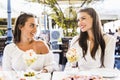 Two beautiful young women smiling and having a fruit salad in a Royalty Free Stock Photo