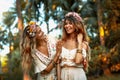 Two beautiful young woman in summer dresses outdoors at sunset Royalty Free Stock Photo