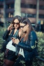 Two beautiful young women using smart phone Royalty Free Stock Photo